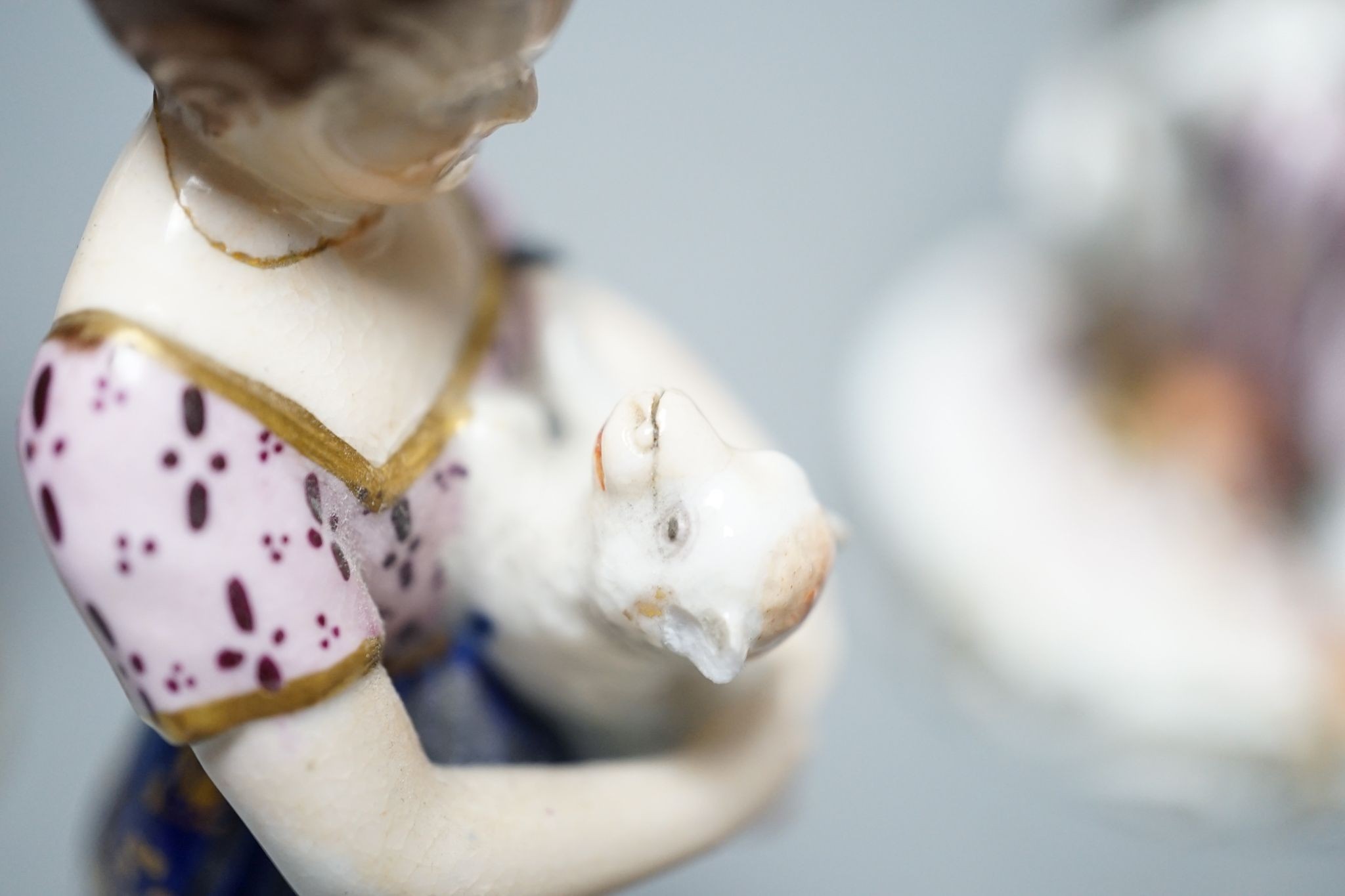 A Minton porcelain figure of a lady seated with a dog c.1830, a pair of Derby figures of a girl and a boy with a dog and a sheep, and a Bloor Derby vase